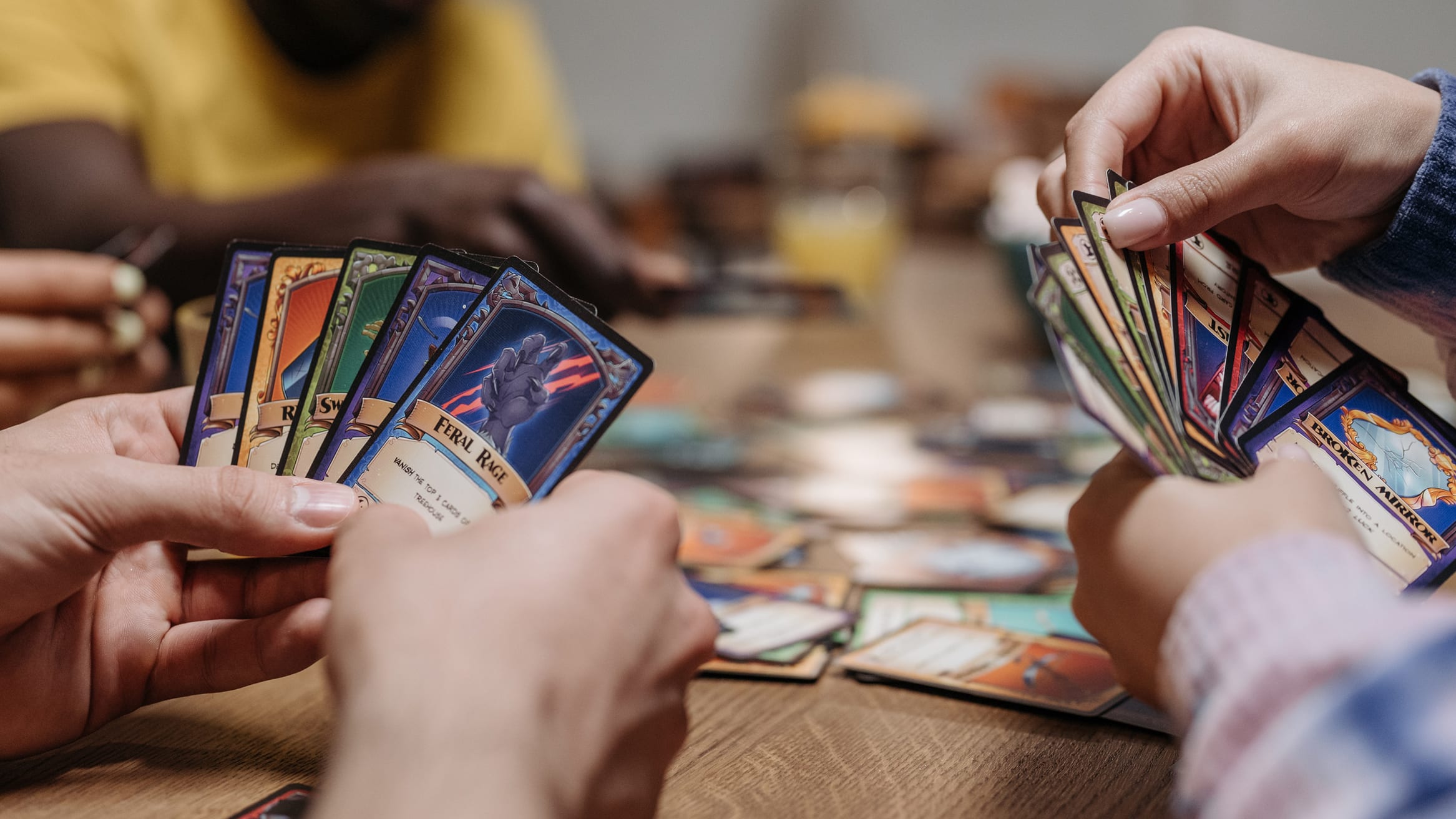 Two hands of cards with cards on the table